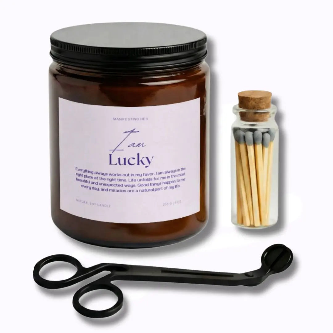 Candle jar with 'Law of Lucky' label, matches, and candle snuffer on a white background