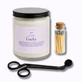 Candle jar with 'Law of Lucky' label, matches, and candle snuffer on a white background